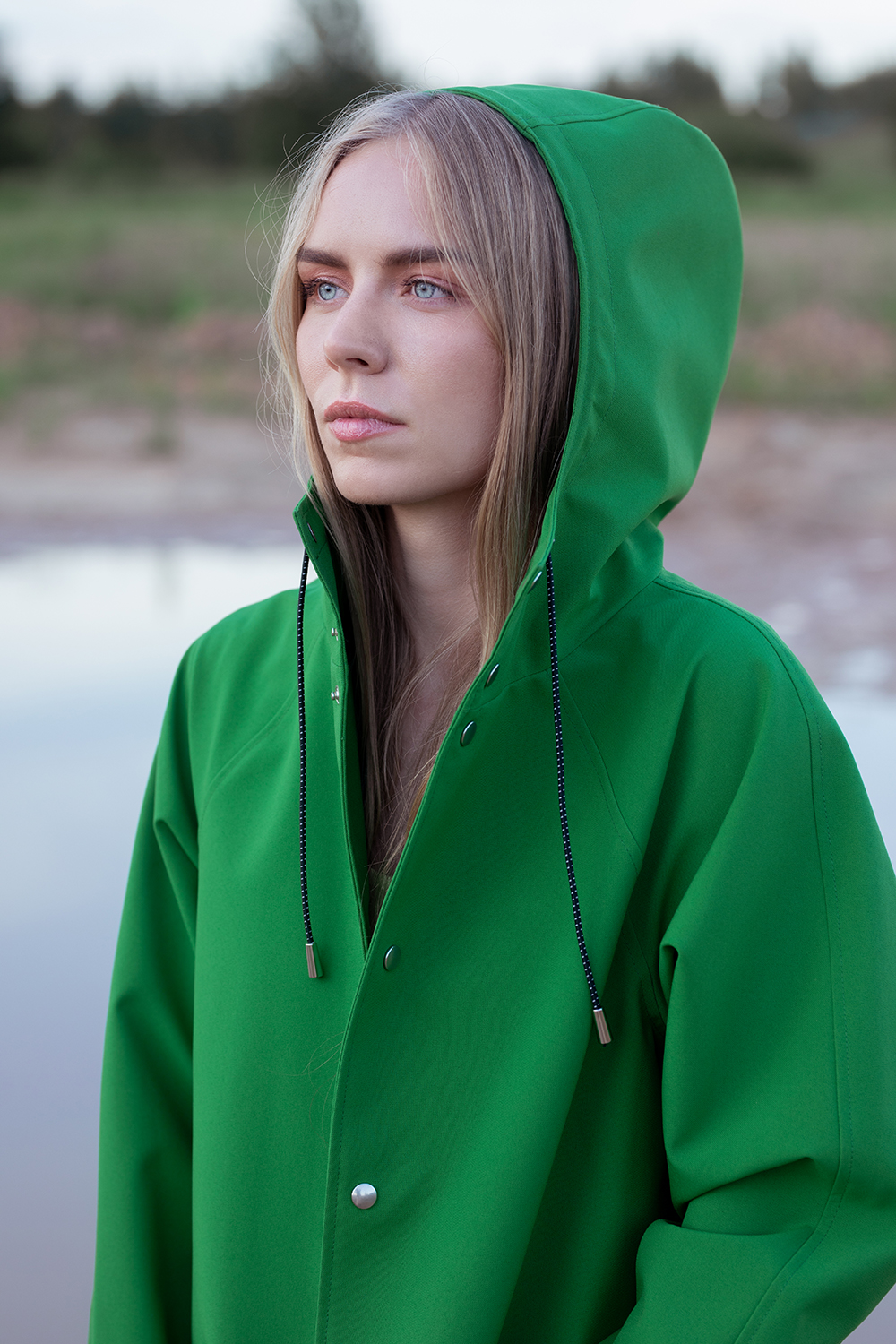 A woman wearing a waterproof, windproof and breathable raincoat in the nature